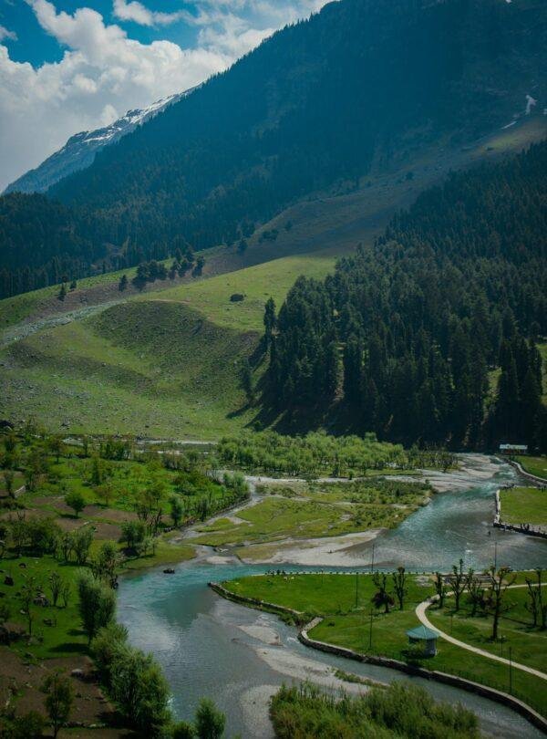 Romantic Betaab Valley scenery with lush green meadows and Lidder River at Pahalgam, Kashmir, India