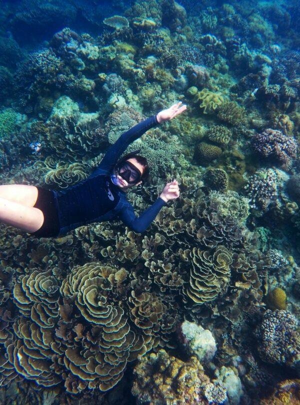 Snorkeling in a turquoise lagoon at a Maldives luxury resort with vibrant marine life