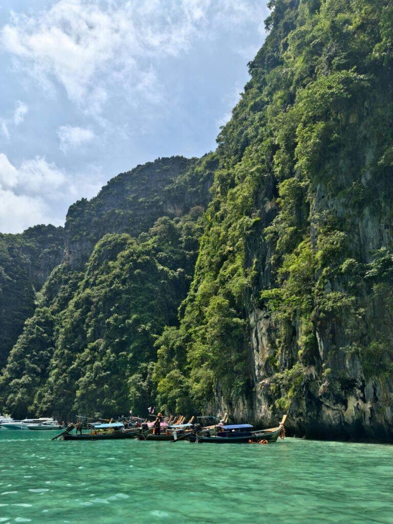 Phi Phi Islands speedboat tour crossing the Andaman Sea with limestone islands in the distance