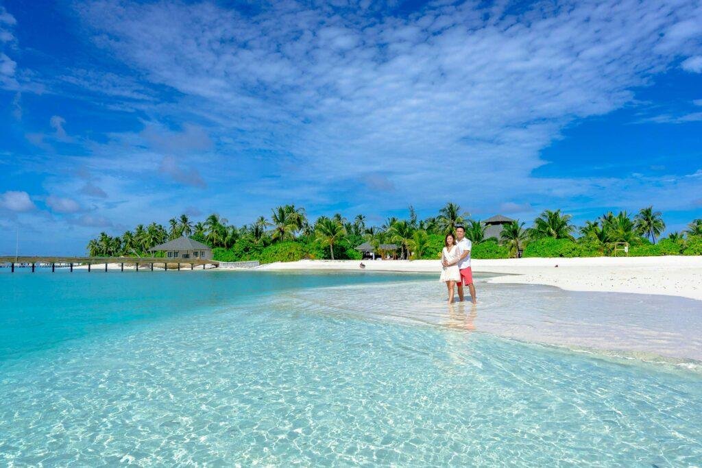 Romantic couple enjoying a Maldives luxury resort honeymoon with ocean view