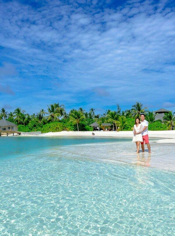 Romantic couple enjoying a Maldives luxury resort honeymoon with ocean view