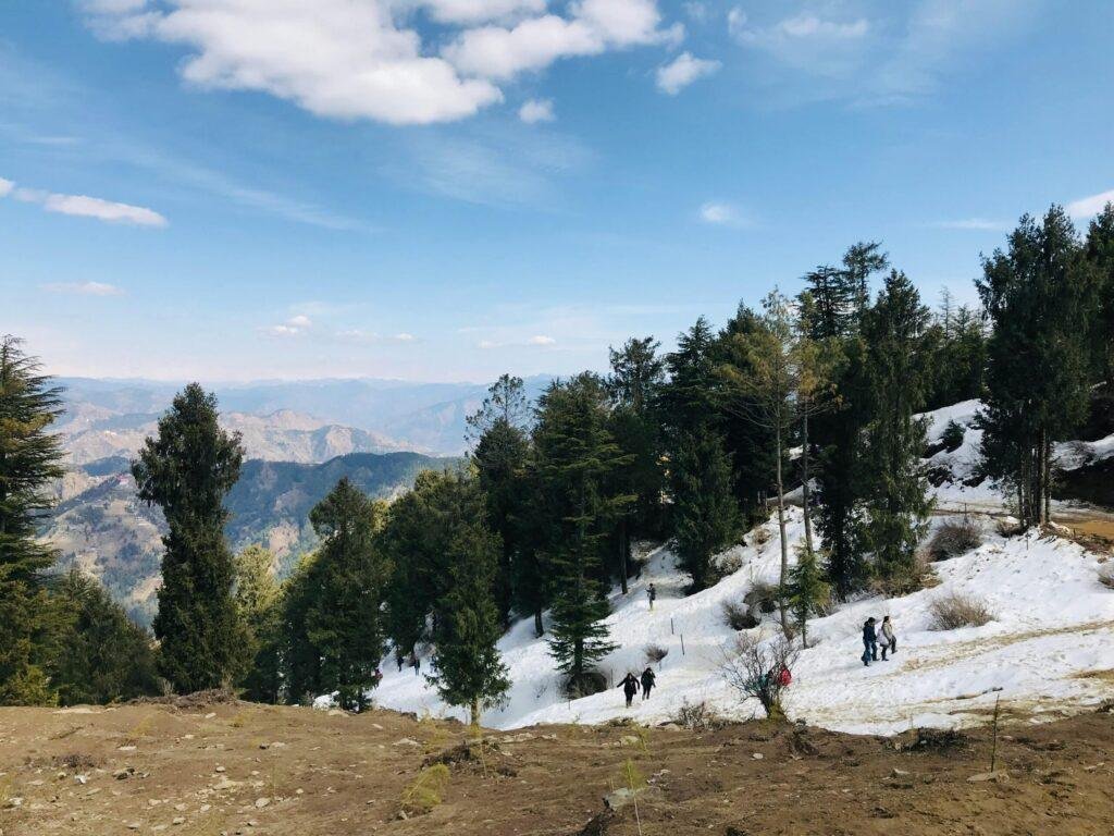 People enjoying snow activities at Kufri snow point near Shimla, Himachal Pradesh